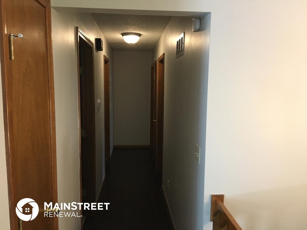 a hallway with doors and a light on the ceiling