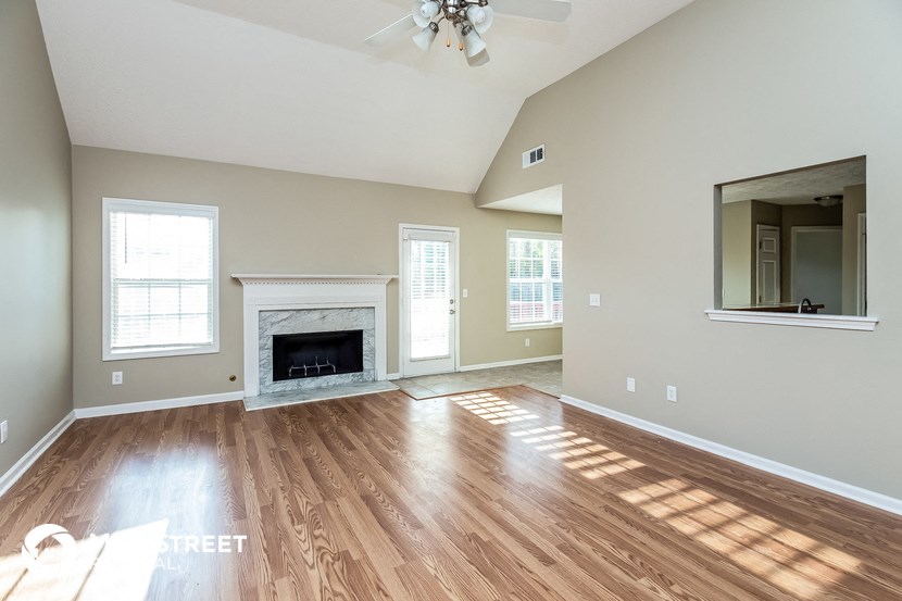 the living room has a fireplace and hardwood floors