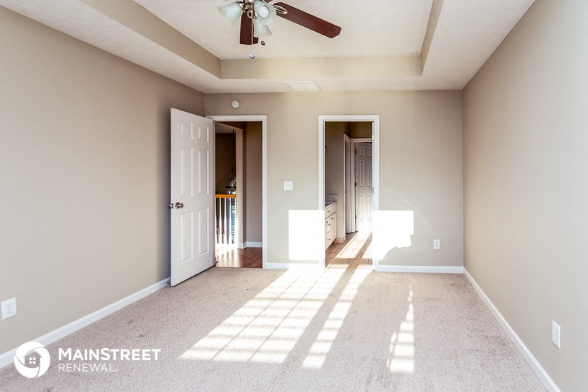 the master bedroom is spacious and has a ceiling fan