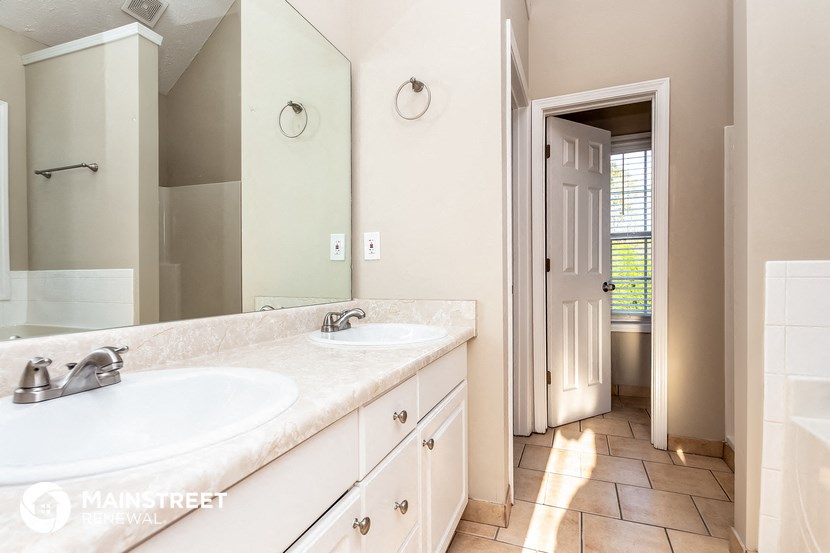 a bathroom with two sinks and a large mirror
