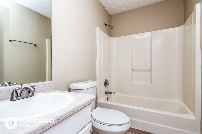 a bathroom with a sink toilet and a bath tub