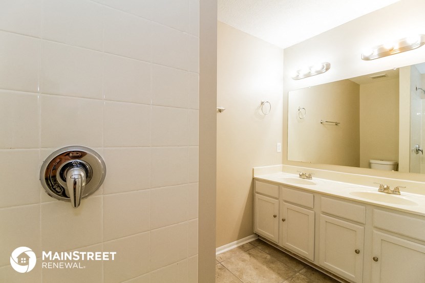 a bathroom with a vanity and a mirror and a sink