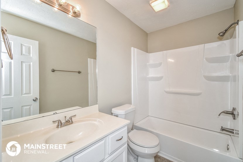 a bathroom with a sink and a tub and a toilet