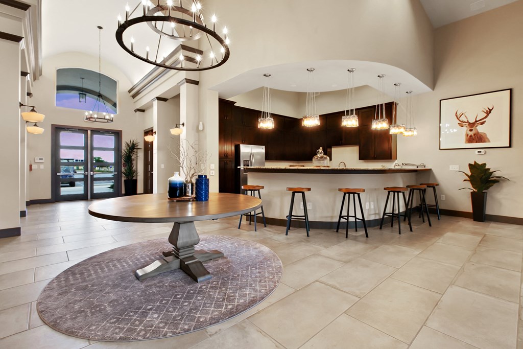 a living room with a kitchen and a table