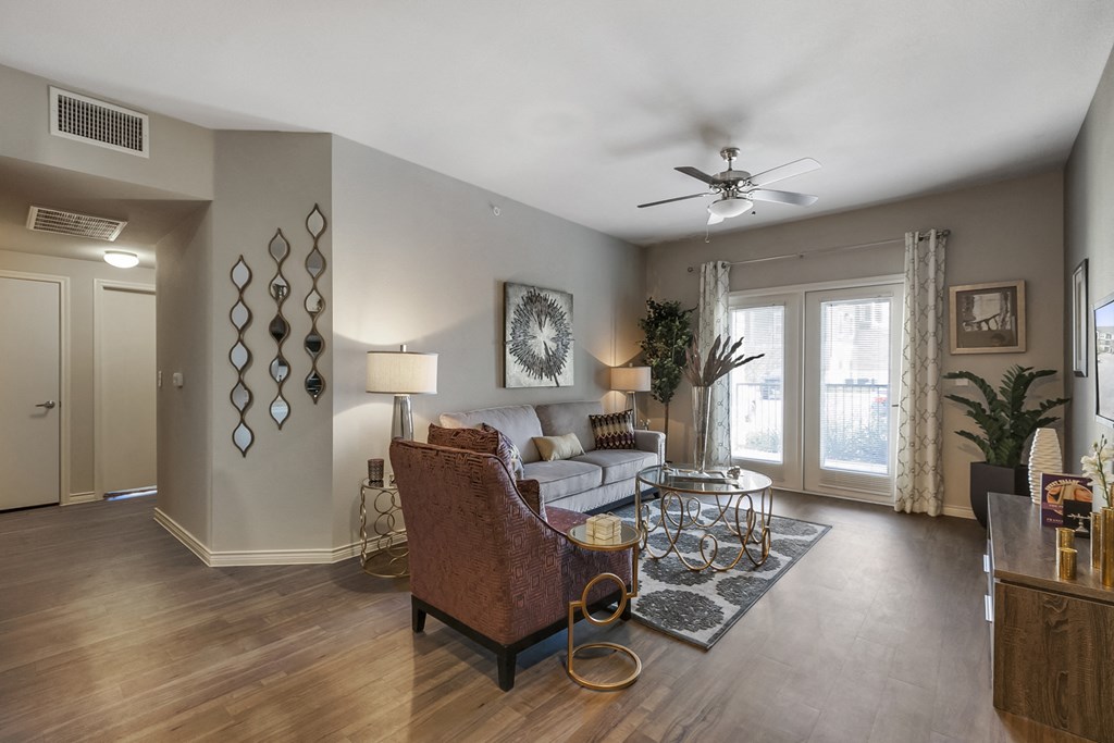 a living room with a couch and a ceiling fan