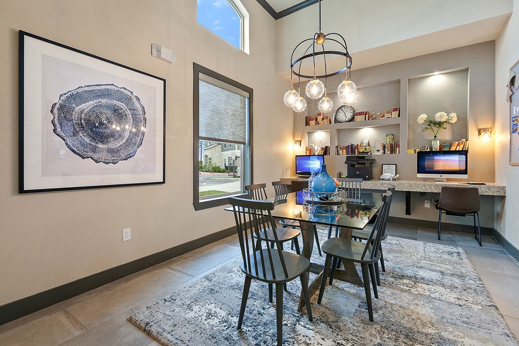 a dining area with a glass table and chairs and a living room with a tv