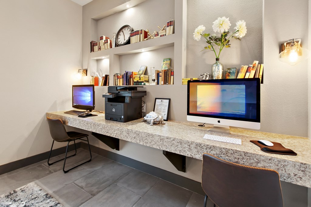 two computers sitting on a desk in a room