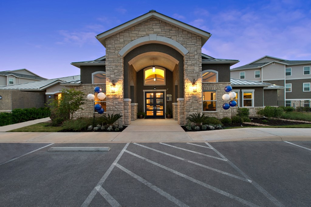 the entrance to a building with balloons in front of it