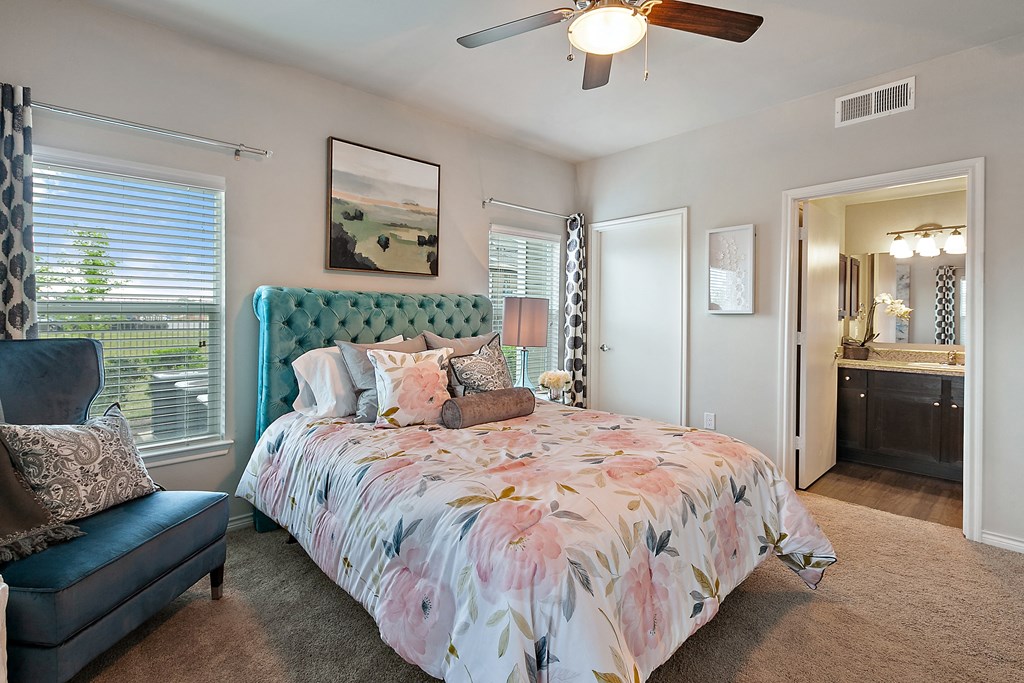a bedroom with a large bed and a ceiling fan