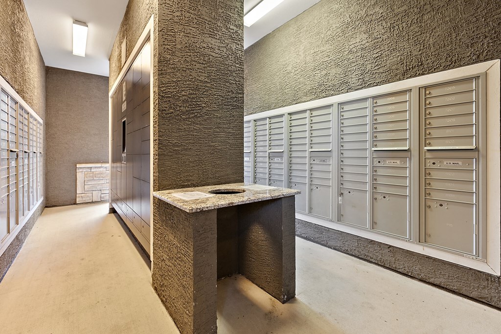 a large walk in closet with lockers and a counter