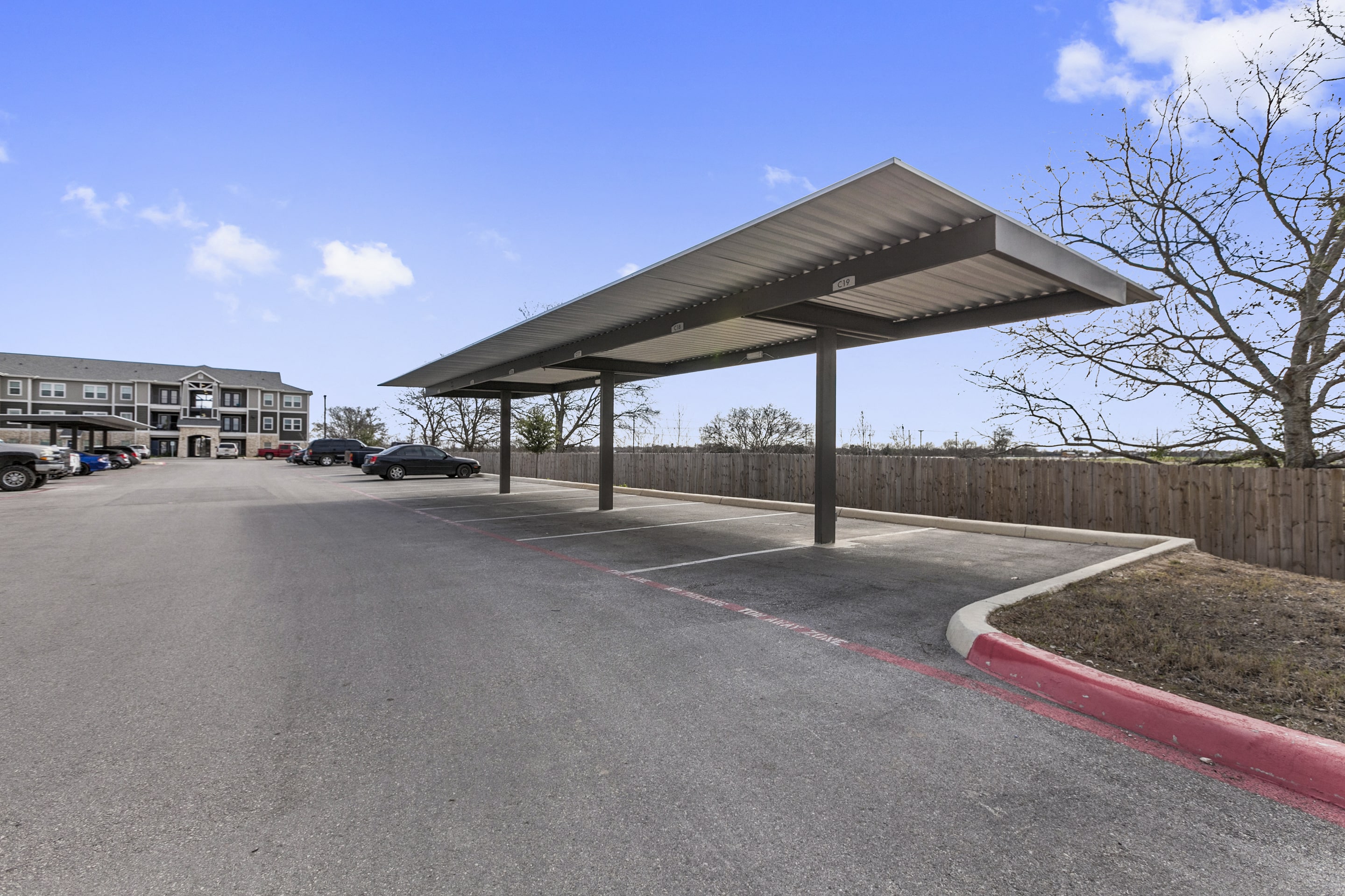 a parking lot with awnings on the side of a road