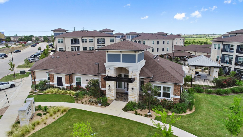 an aerial view of a large building with a street in the background