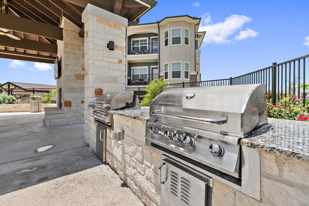 a large stainless steel barbecue grill in the backyard of a house