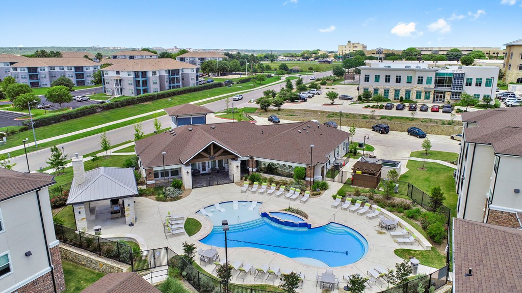 an aerial view of a large swimming pool in front of a building