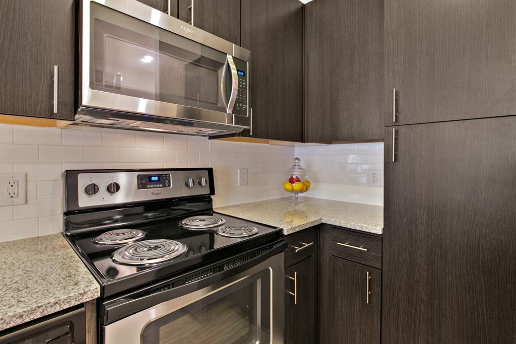 a kitchen with stainless steel appliances and granite counter tops