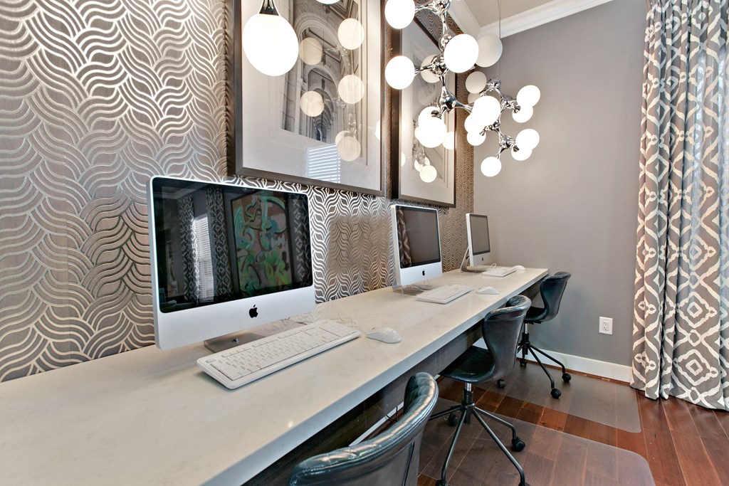 a computer desk with two monitors and a keyboard on it