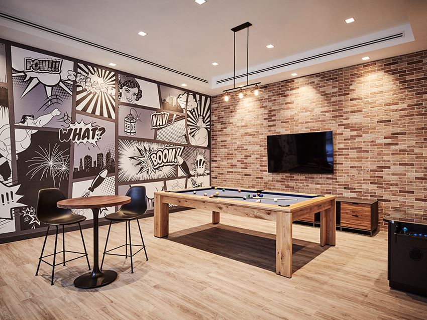 a games room with a pool table and a tv