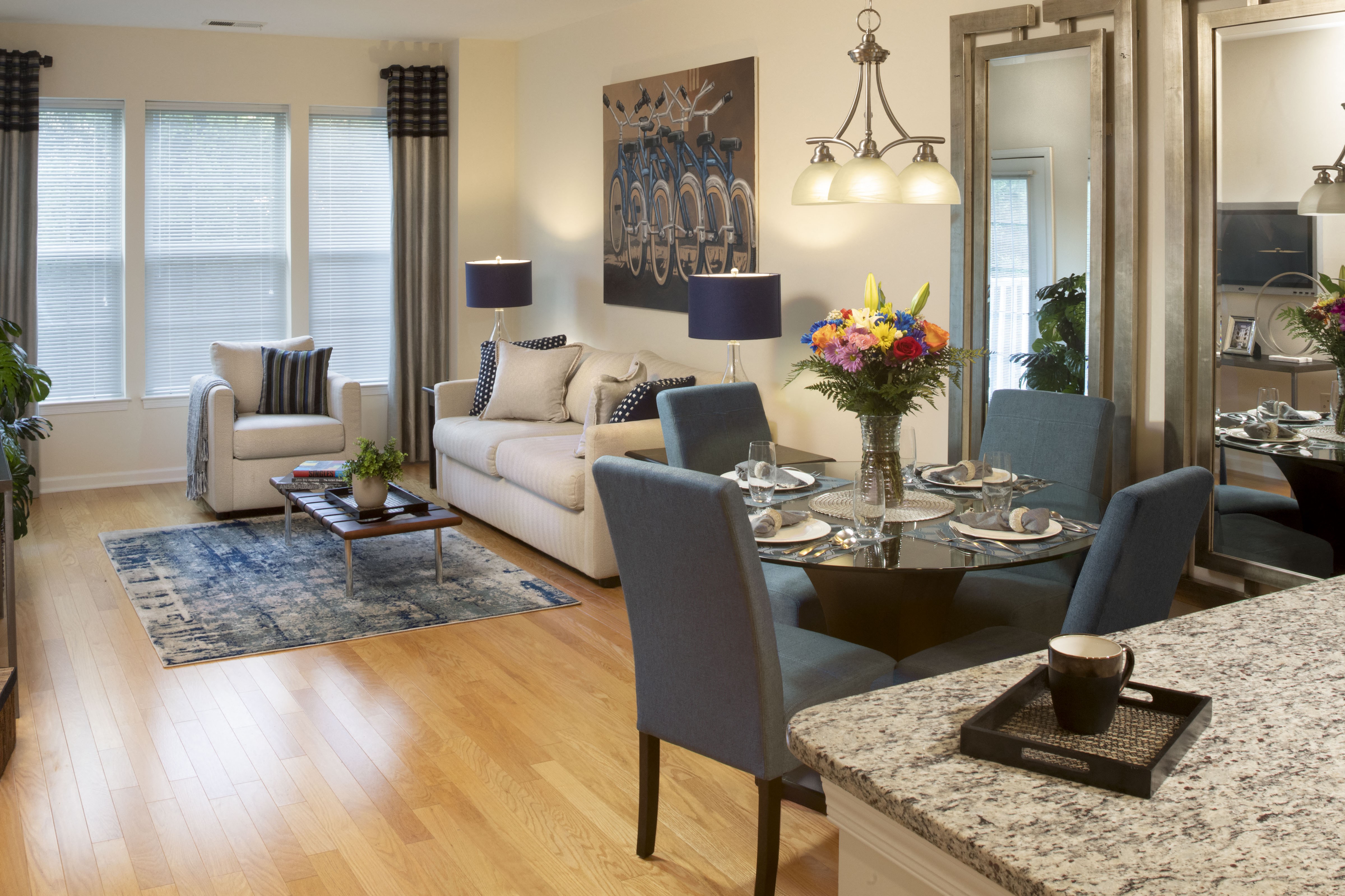 a living room and dining room with a table and chairs