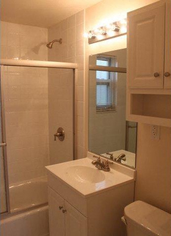 a bathroom with a sink and a shower and a mirror