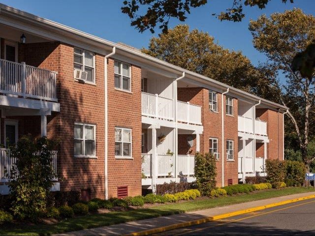 a red brick apartment building with white balconies