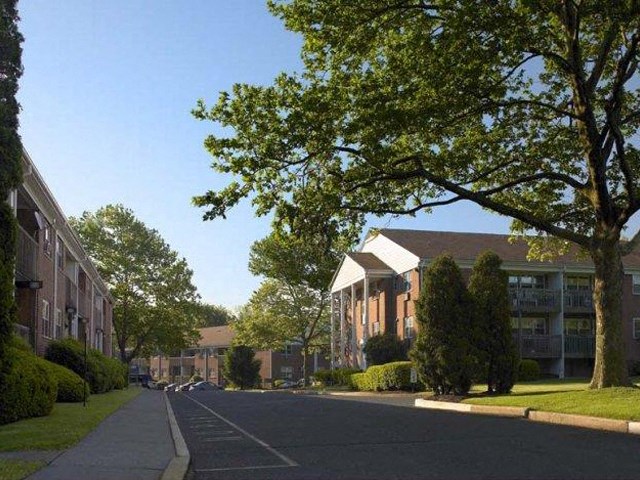 an empty street in front of an apartment building