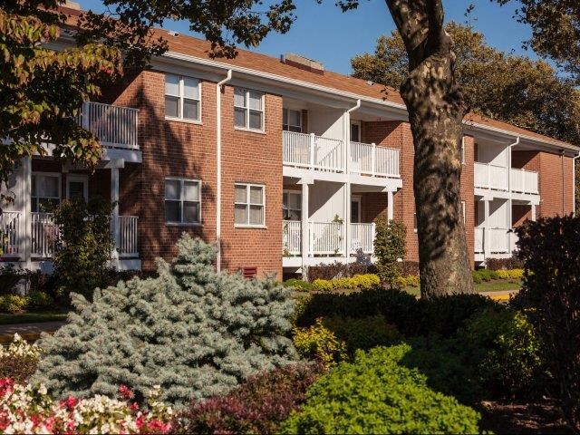 a red brick apartment building with white balconies