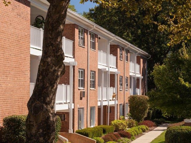 a brick building with a tree in front of it