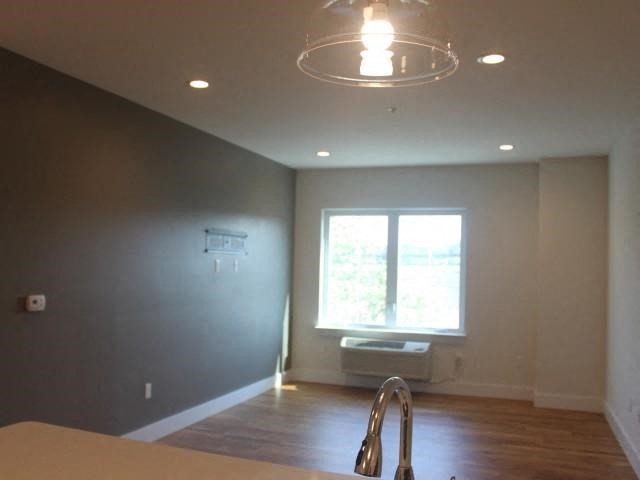 an empty living room with a window and a sink