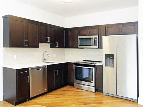 a kitchen with stainless steel appliances and a refrigerator