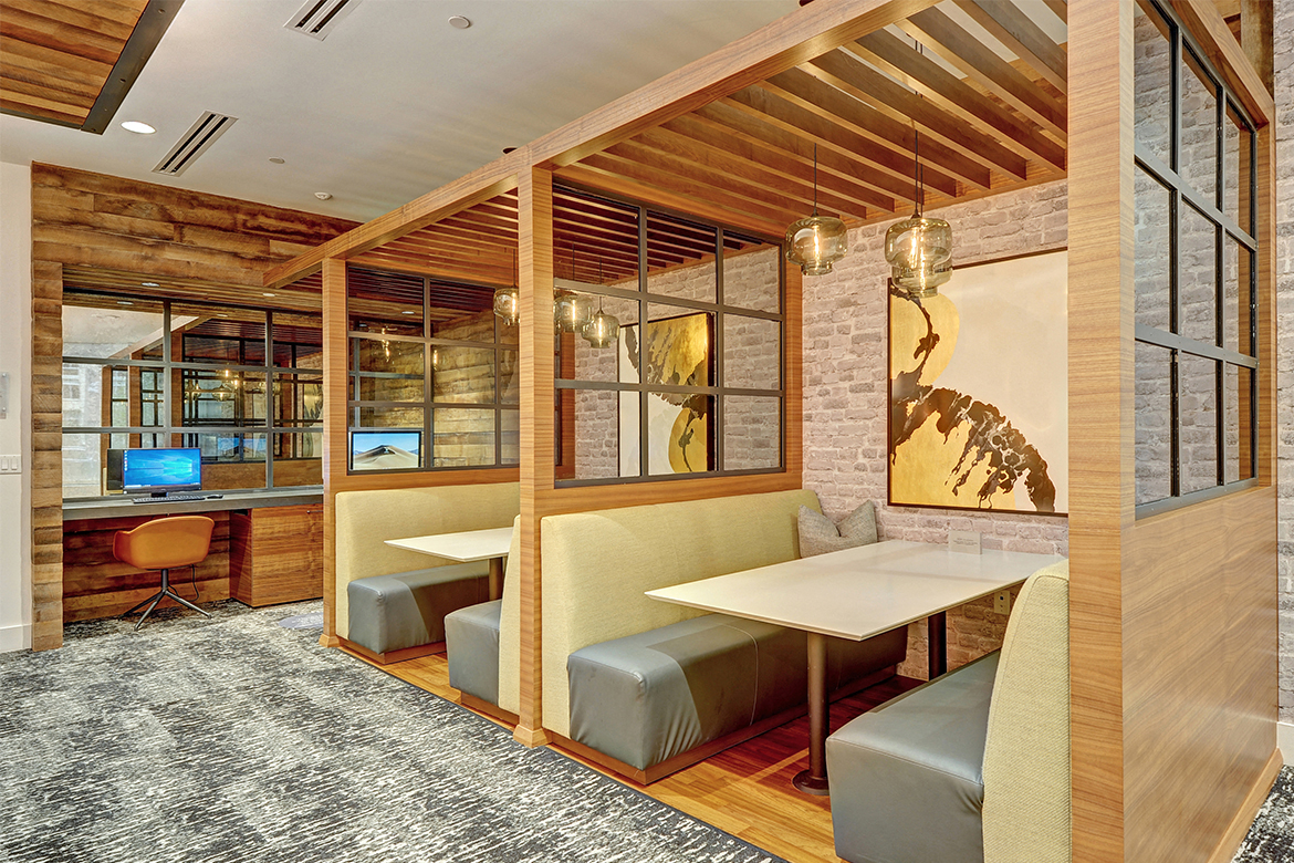 a meeting room with desks and chairs and a table with chairs