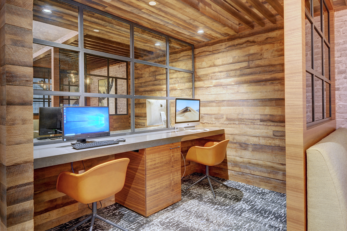 a home office with a desk and two computer monitors