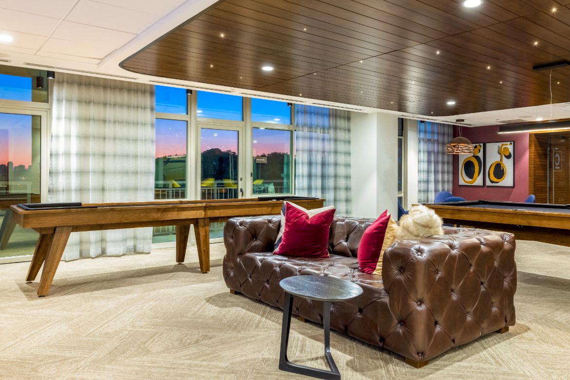 a living room with a couch and a pool table