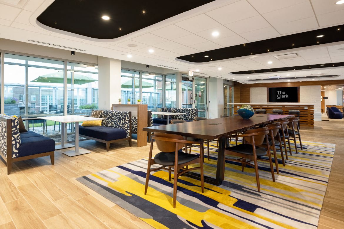 a large table and chairs in a room with glass doors