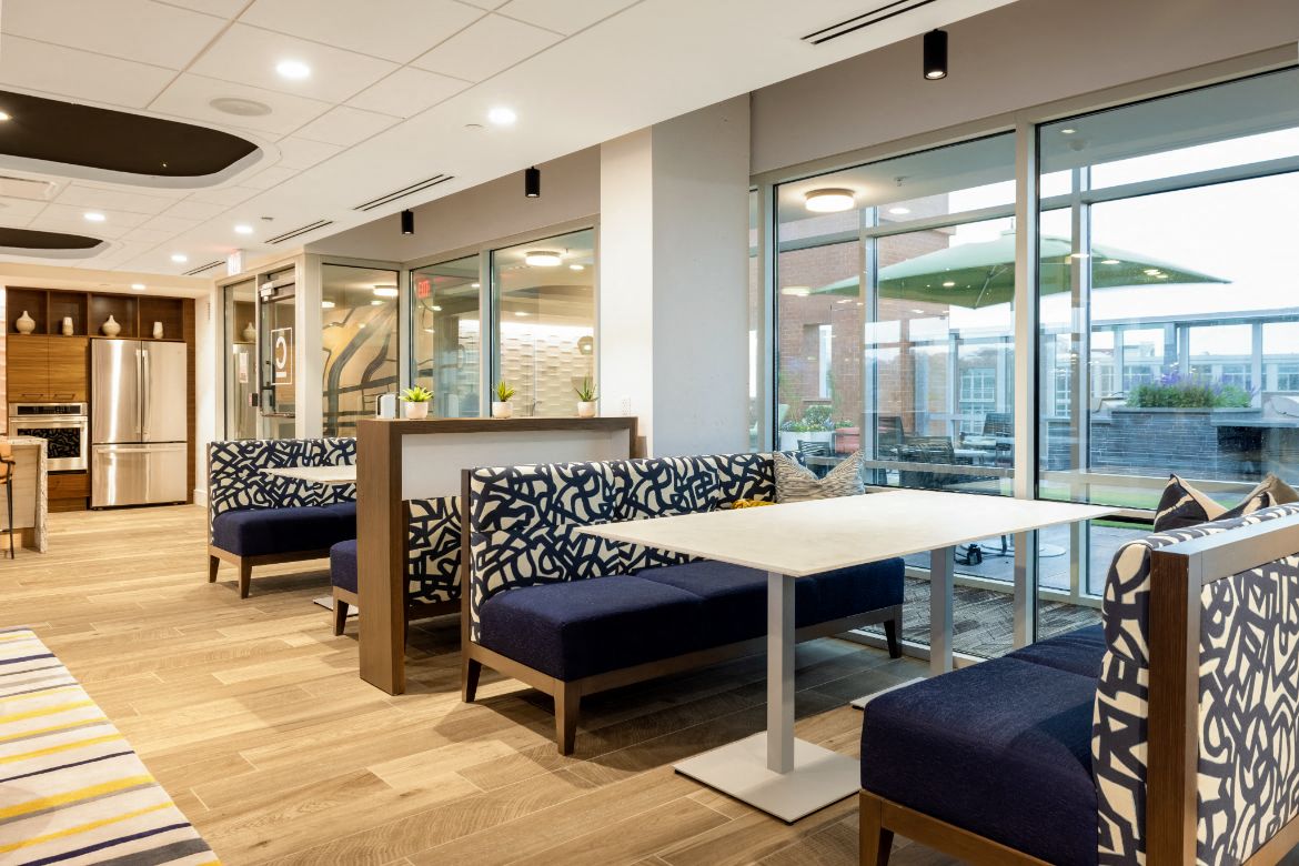a seating area with tables and chairs in a room