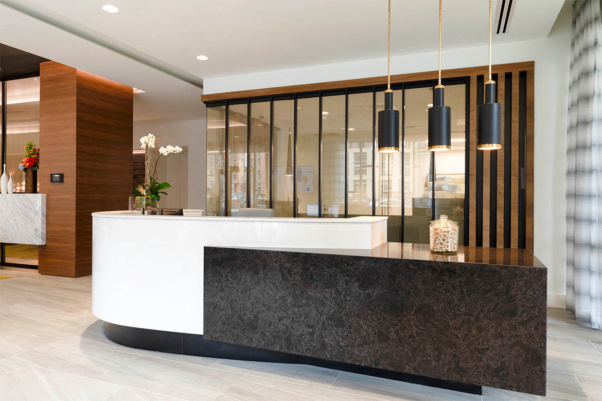 the lobby or reception area of a hotel with a reception desk