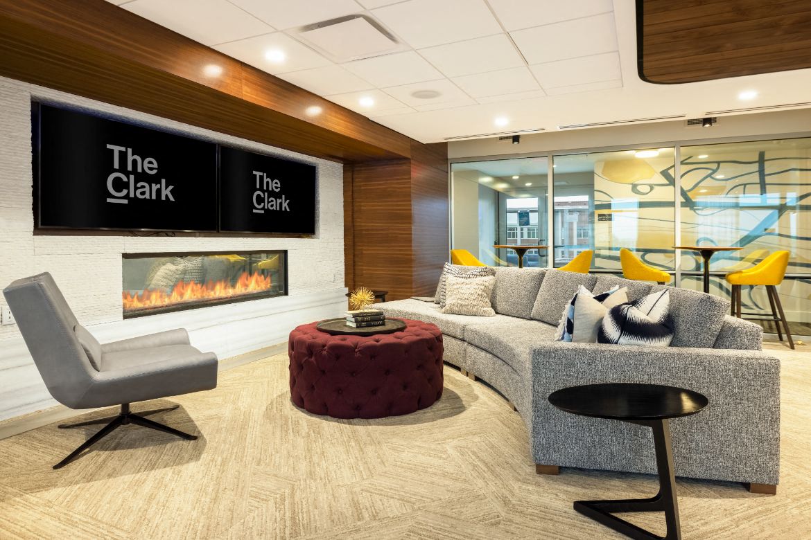 the lobby of the clark with a couch and a fireplace