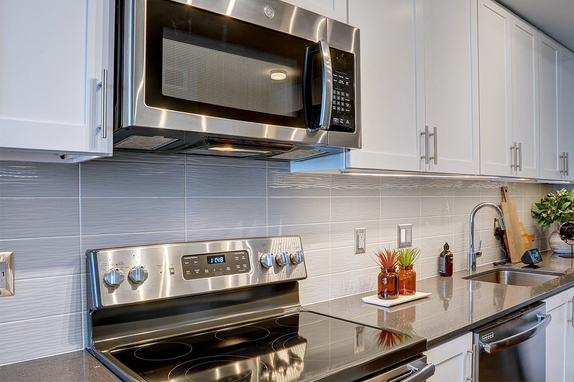 a kitchen with stainless steel appliances and a microwave
