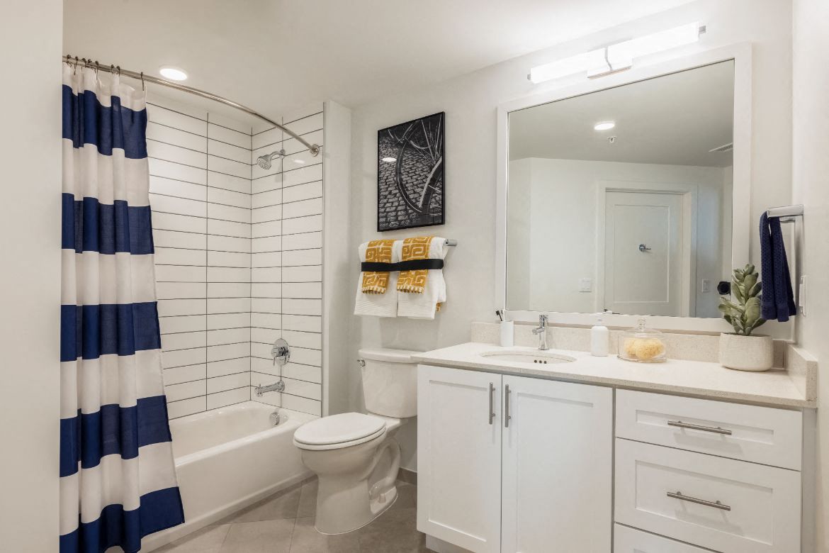 a white bathroom with a shower toilet and sink