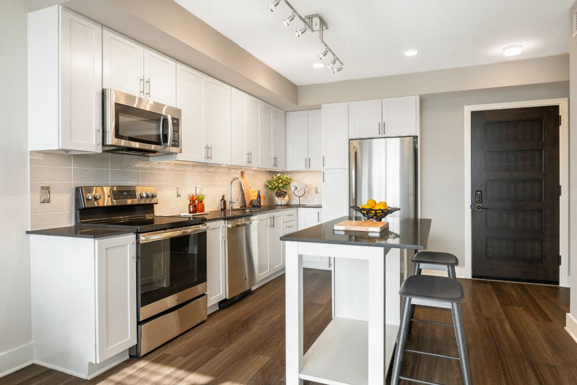 a kitchen with white cabinets and a counter