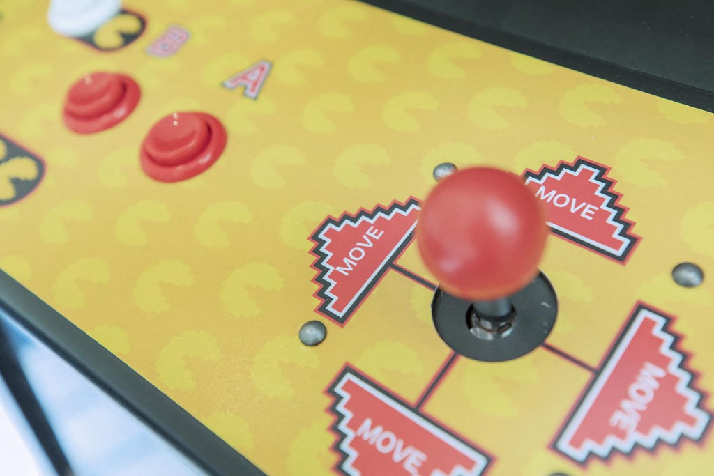 a close up of a pin ball game on a yellow table