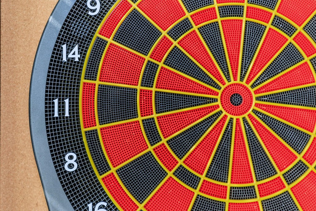 a close up of a dart board with a red and