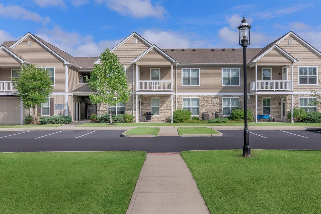 an empty street in front of an apartment building