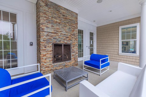 a living room with a fireplace and blue chairs