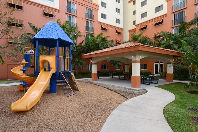 a playground with a slide and a pavilion in an apartment building