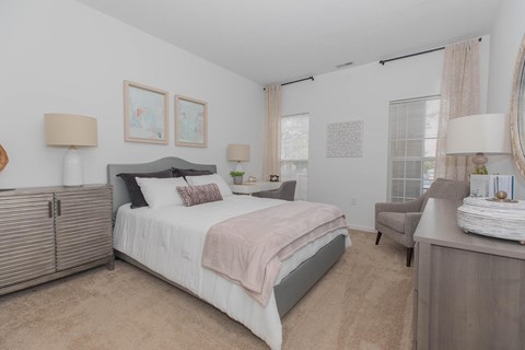 a bedroom with a bed and a dresser and a window