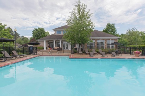 a swimming pool with a house in the background