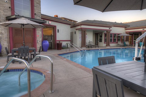 Pet-Friendly Apartments in American Canyon, CA - The Village at Vintage Ranch - Pool with Jacuzzi, Lounge Chairs, and Umbrella Tables