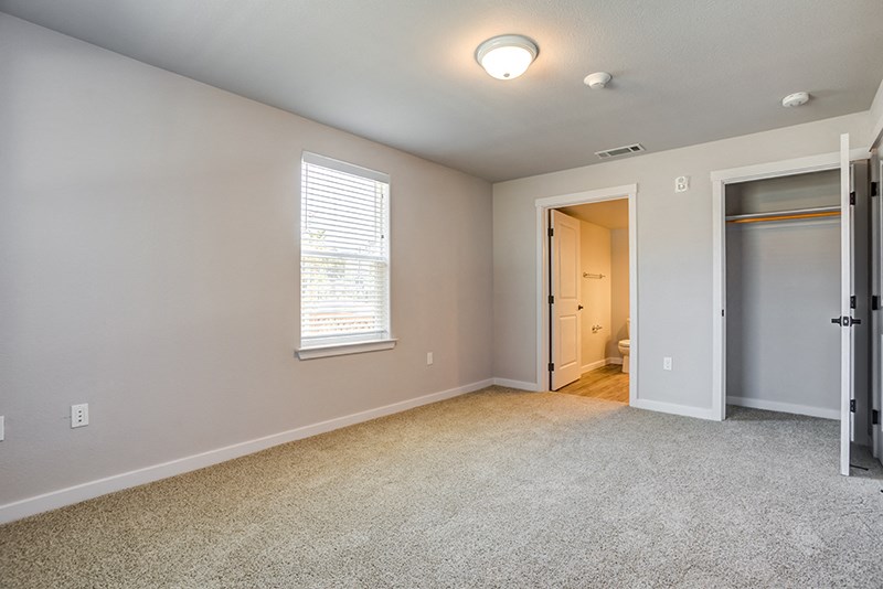 Three-Bedroom Apartments in American Canyon, CA - The Village at Vintage Ranch - Bedroom with Plush Carpet, Spacious Closet, and Large Windows