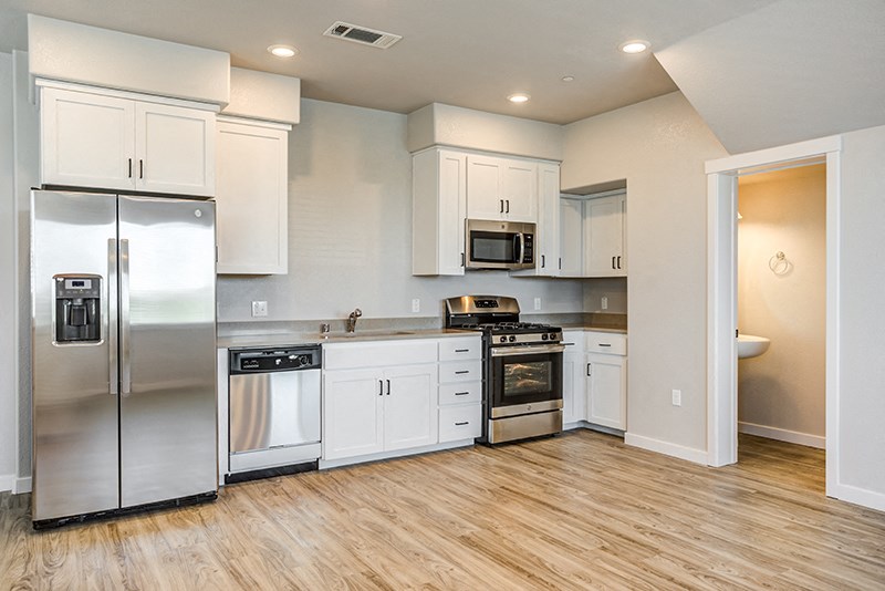 Apartments for Rent Ameican Canyon - Spacious Kitchen with Wood Flooring, Stainless Steel Appliances, and Ample Overhead Lighting