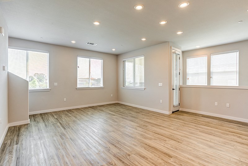 Townhouses for Rent in American Canyon, CA - The Village at Vintage Ranch - Living Room with Wood-Style Flooring, Open Floorplan, and Natural Lighting